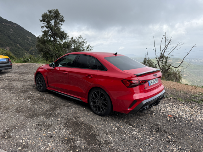 Rear 3/4 view of red Audi RS3 sedan